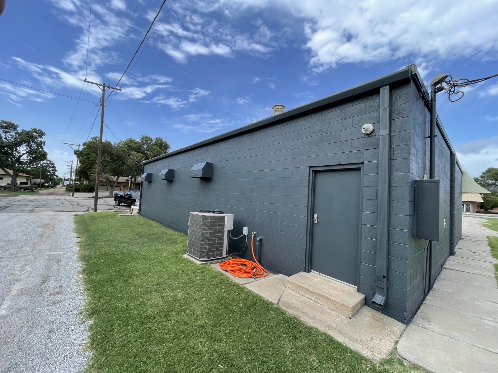After: commercial block building painted deep slate