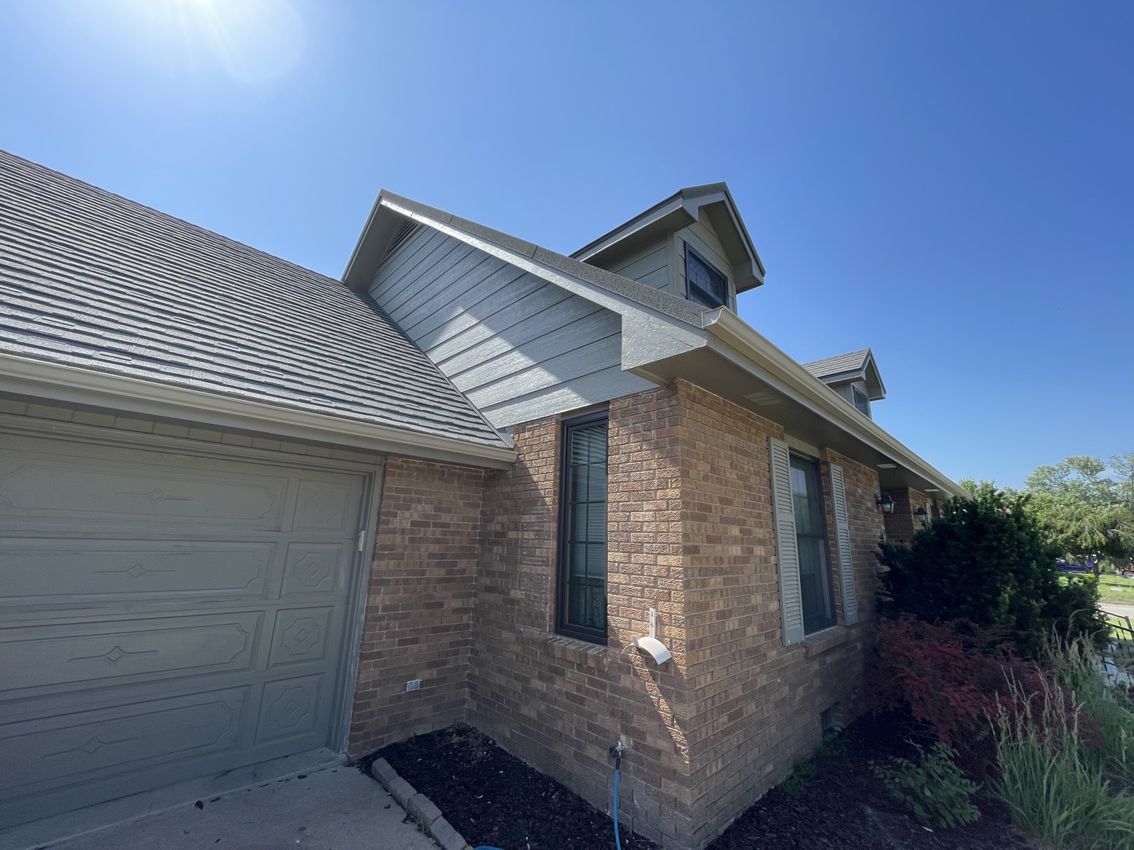 After: repainted dormers, trim and garage door