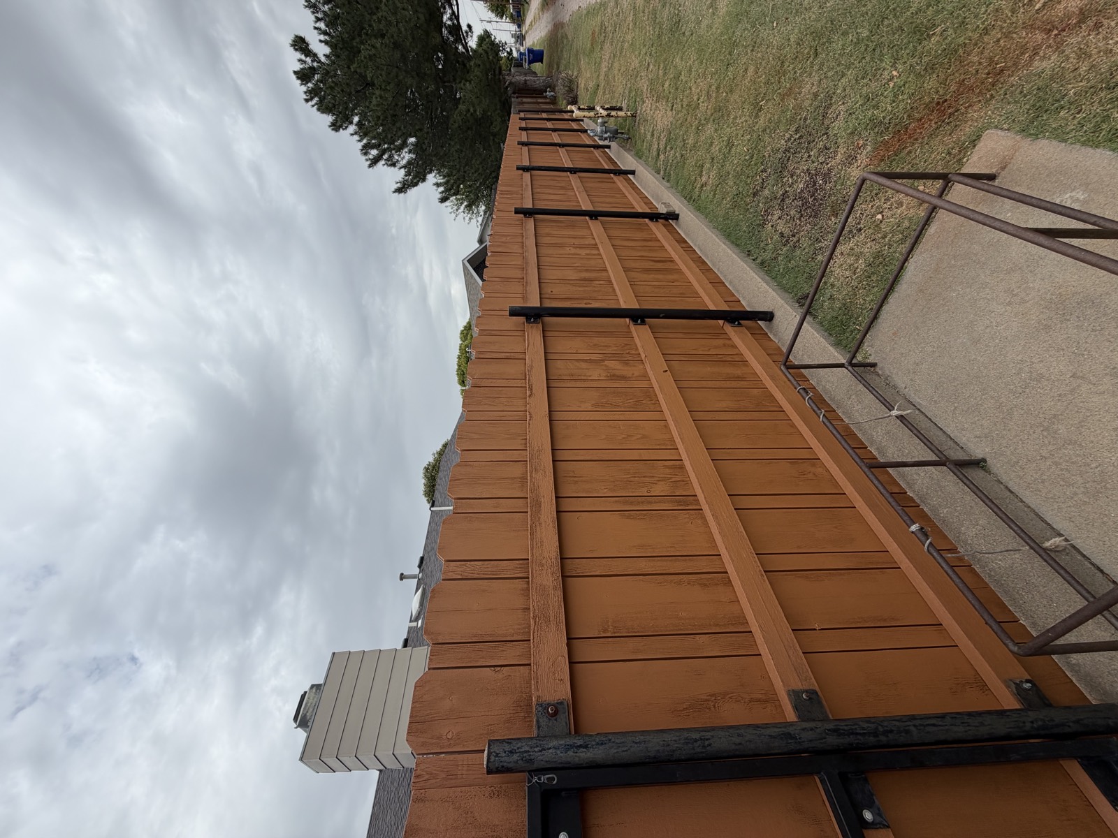 After: privacy fence with fresh, even cedar-tone stain