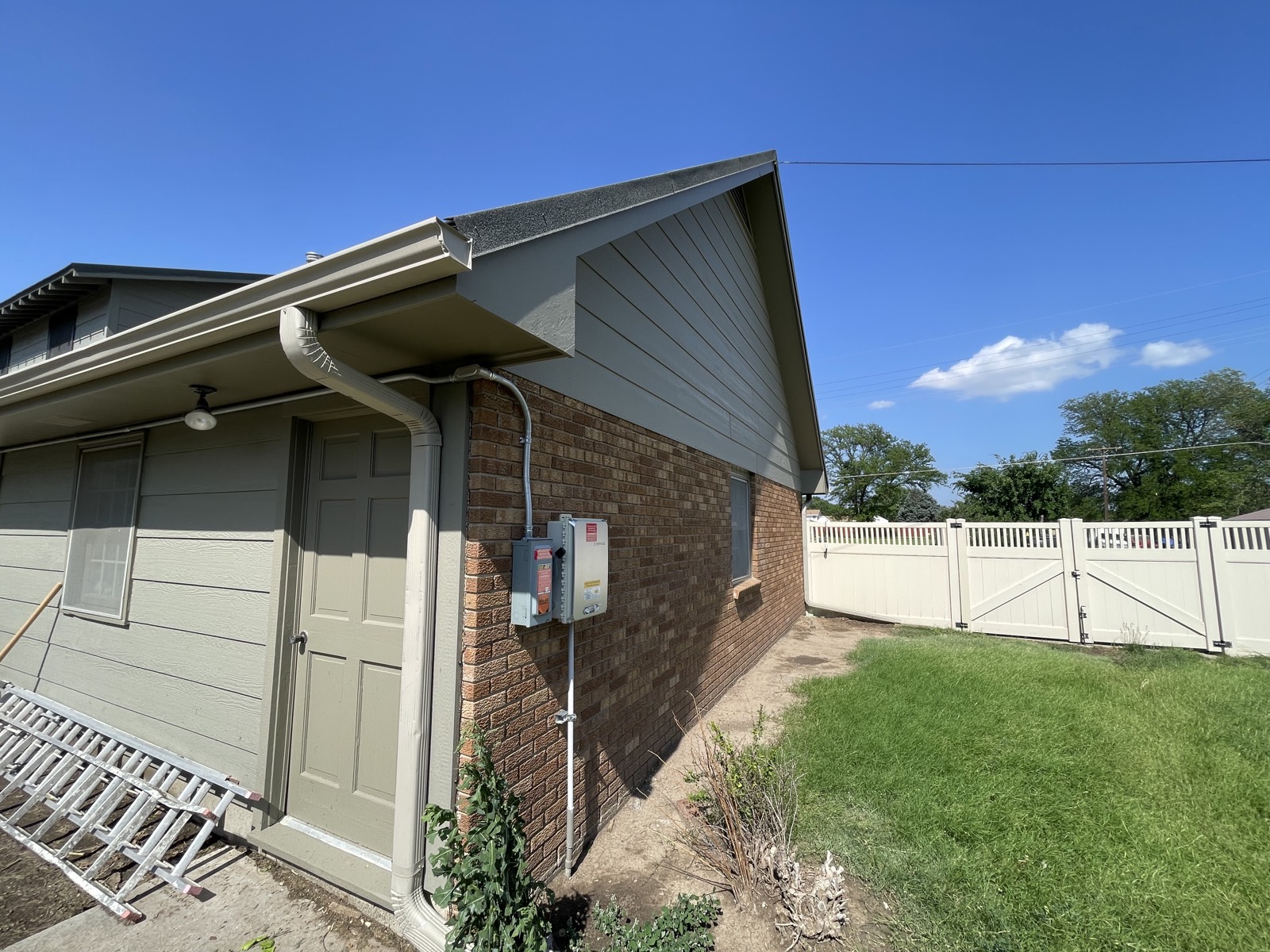 After: gable and eaves repainted in fresh gray